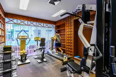 a fitness room with a gym with a large window at Andaman Seaview, Karon Beach - SHA Plus in Karon Beach
