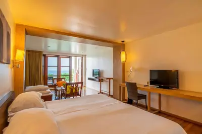 a hotel room with two beds and a television at Best Western Phuket Ocean Resort in Karon Beach