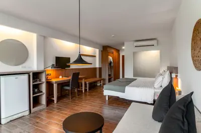 a hotel room with a bed and a desk at Sunprime Kamala Beach in Kamala Beach
