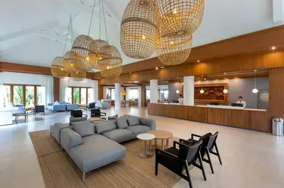 a lobby with a couch and chairs and a bar at Sunwing Bangtao Beach in Bang Tao Beach