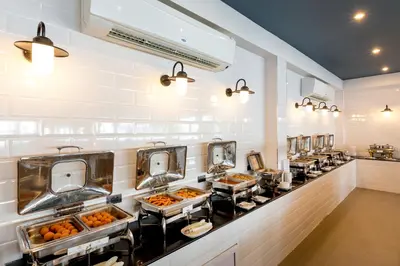 a buffet line with many trays of food at Sunwing Bangtao Beach in Bang Tao Beach