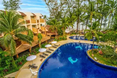 an aerial view of a resort pool with chairs and palm trees at Best Western Premier Bangtao Beach Resort & Spa in Bang Tao Beach