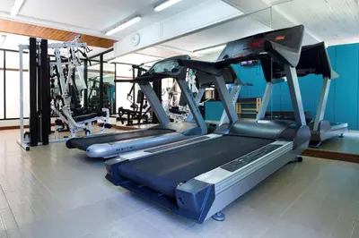 a gym with two treadmills and a treadmill at Best Western Premier Bangtao Beach Resort & Spa in Bang Tao Beach