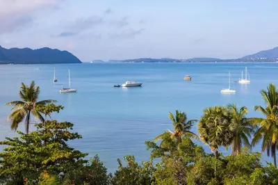 a view of a large body of water with boats at By The Sea in Panwa Beach