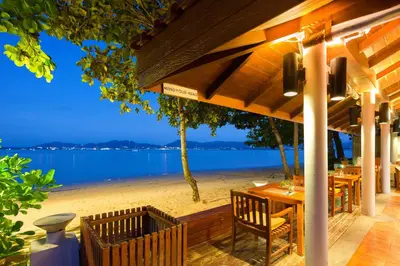 a restaurant with a view of the beach at By The Sea in Panwa Beach