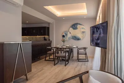 a dining room and kitchen with a table and chairs at The Pe La Resort, Phuket - SHA Extra Plus in Kamala Beach