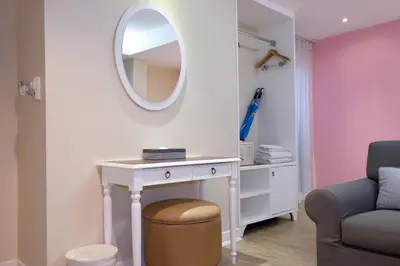 a dressing table with a mirror and a stool at The Beach Boutique House in Kata Beach