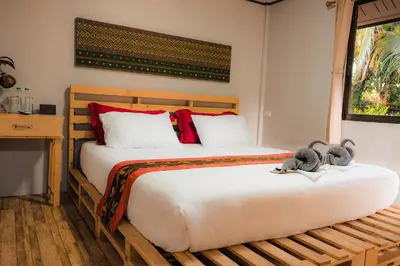 a bedroom with a bed with two stuffed animals on it at Cocco House in Ao Nang Beach