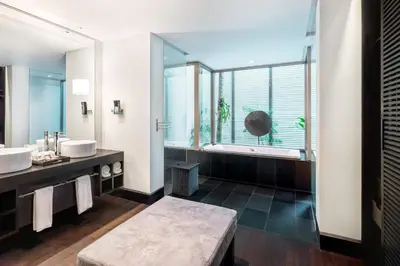 a bathroom with two sinks and a large window at Twinpalms Surin Beach Phuket in Surin Beach
