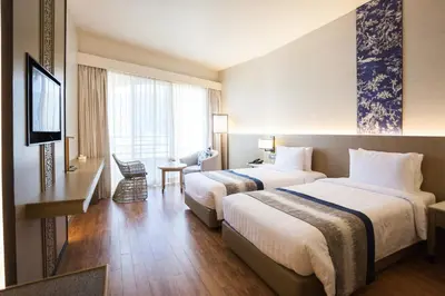 a hotel room with two beds and a television at The Royal Paradise Hotel & Spa in Patong Beach
