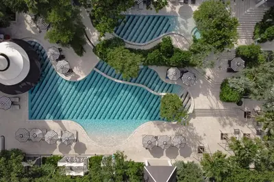an overhead view of a swimming pool with trees andanas at The Royal Paradise Hotel & Spa in Patong Beach
