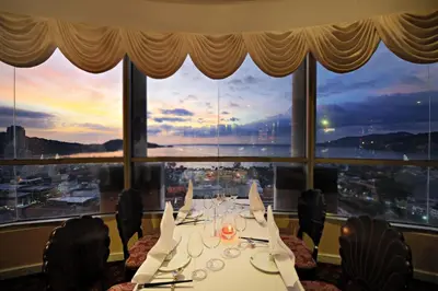 a long table in a room with a large window at The Royal Paradise Hotel & Spa in Patong Beach