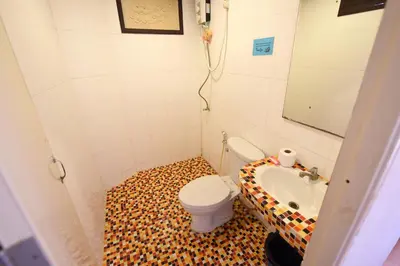 a small bathroom with a toilet and a sink at Phi Phi Twin Palms Bungalow in Phi Phi Don