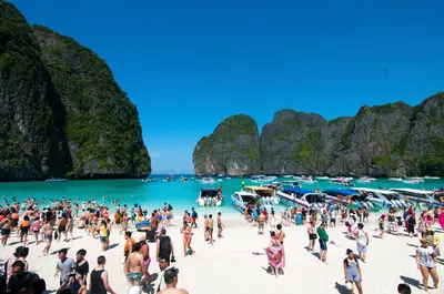 a crowd of people on a beach in halong bay at Phi Phi Twin Palms Bungalow in Phi Phi Don