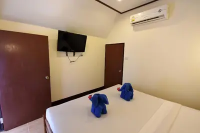 a bedroom with two blue elephants sitting on a bed at Phi Phi Twin Palms Bungalow in Phi Phi Don