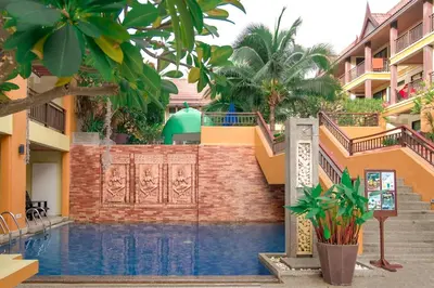 a pool in the middle of a building at Diamond Cottage Resort & Spa in Karon Beach