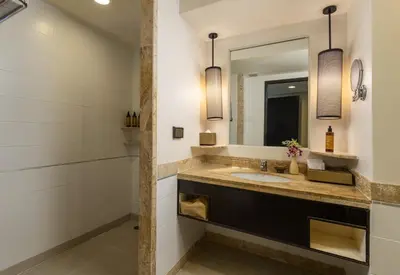 a bathroom with a sink and a mirror at Centara Kata Resort Phuket in Kata Beach