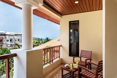 a patio with a table and chairs on a balcony at Patong Paragon Resort & Spa SHA Extra Plus in Patong Beach