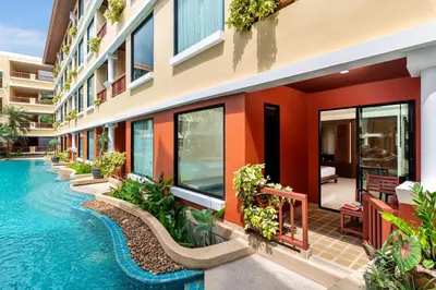 an external view of a building with a swimming pool at Patong Paragon Resort & Spa SHA Extra Plus in Patong Beach