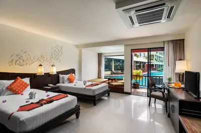 a hotel room with two beds and a living room at Patong Paragon Resort & Spa SHA Extra Plus in Patong Beach