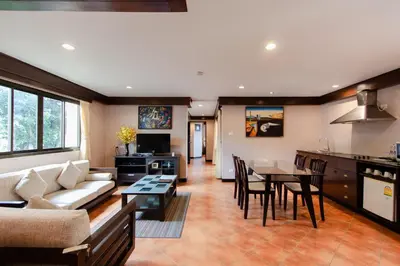 a living room with a couch and a table at Karon Sea Sands Resort-SHA PLUS in Karon Beach