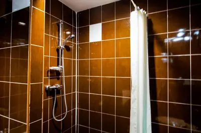 a bathroom with a shower with a shower curtain at Karon Sea Sands Resort-SHA PLUS in Karon Beach