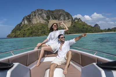 a man and woman sitting on the back of a boat at Holiday Inn Resort Krabi Ao Nang Beach by IHG in Ao Nang Beach