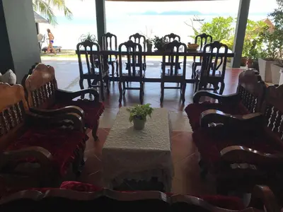 a group of chairs and a table with a plant on it at Koh Kwang Seaview in Klong Muang Beach