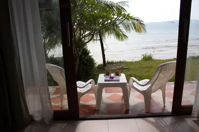 a table with two chairs and a table with a view of the ocean at Koh Kwang Seaview in Klong Muang Beach
