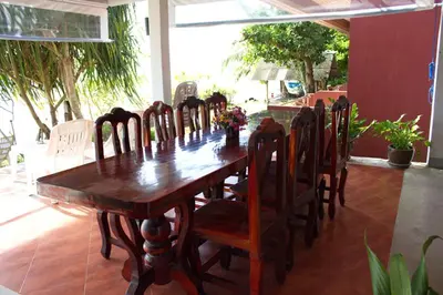a wooden table and chairs in a room at Koh Kwang Seaview in Klong Muang Beach