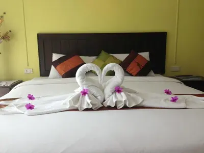 two swansuitsrendered to look like hearts on a bed at Koh Kwang Seaview in Klong Muang Beach