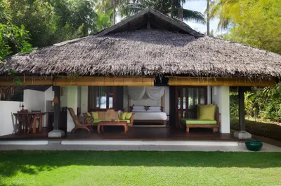 a pavilion with a bed and chairs and a thatch roof at Koyao Island Resort in Ko Yao Noi