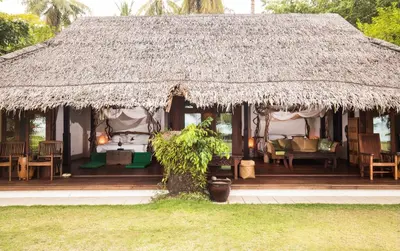 a hut with a bed and a grass roof at Koyao Island Resort in Ko Yao Noi