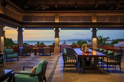 a restaurant with tables and chairs and a view of the ocean at Phuket Marriott Resort and Spa, Nai Yang Beach in Nai Yang Beach