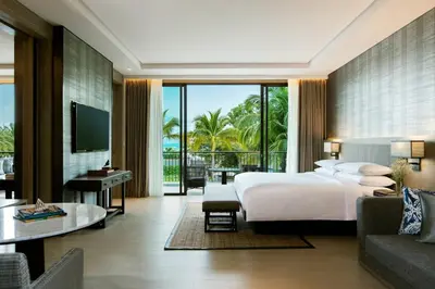 a bedroom with a bed and a living room at Phuket Marriott Resort and Spa, Nai Yang Beach in Nai Yang Beach