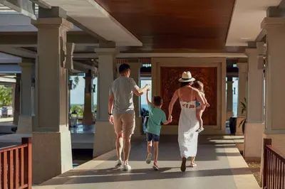 a family walking down the hallway of a house at Phuket Marriott Resort and Spa, Nai Yang Beach in Nai Yang Beach