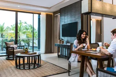 a group of people sitting at a table in a living room at Phuket Marriott Resort and Spa, Nai Yang Beach in Nai Yang Beach