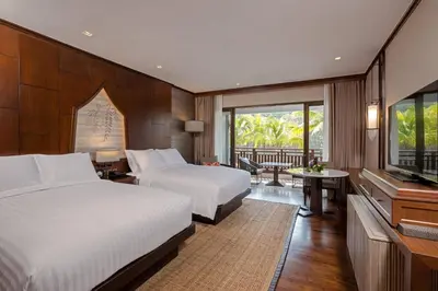 a hotel room with two beds and a television at Phuket Marriott Resort and Spa, Nai Yang Beach in Nai Yang Beach