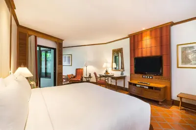 a bedroom with a bed and a flat screen tv at JW Marriott Phuket Resort and Spa in Mai Khao Beach