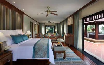 a bedroom with a large bed and a living room at JW Marriott Phuket Resort and Spa in Mai Khao Beach