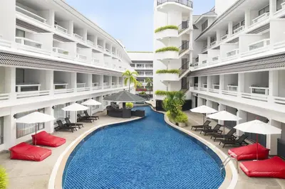 an external view of a hotel with a swimming pool at Radisson RED Phuket Patong Beach in Patong Beach