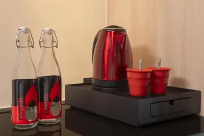 two bottles of coke and red cups on a table at Radisson RED Phuket Patong Beach in Patong Beach