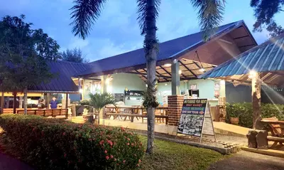 a restaurant with a sign in front of a building at Mild Garden View Resort in Ao Nang Beach