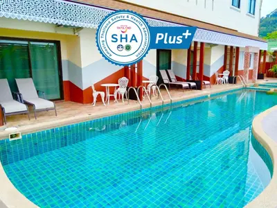 a swimming pool in front of a hotel at Mei Zhou Phuket Hotel - SHA Plus in Phuket Town