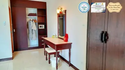 a dressing room with a table and a mirror at Mei Zhou Phuket Hotel - SHA Plus in Phuket Town