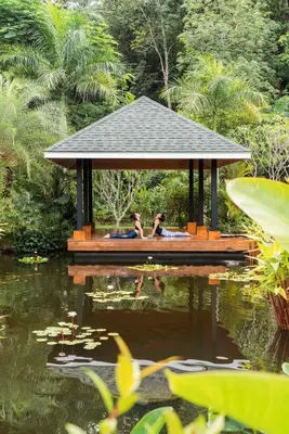 two people in a gazebo over a pond at The Pavilions Phuket in Bang Tao Beach