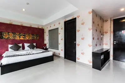 a bedroom with a bed and a red headboard at 7Q Patong Beach Hotel in Patong Beach