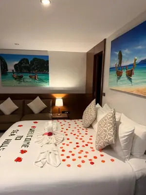a hotel room with a bed with flowers on it at Sea Hills Resort in Patong Beach