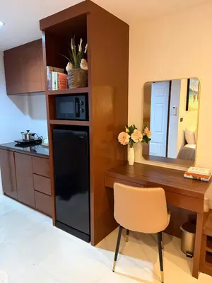 a kitchen with a black refrigerator and a table with a mirror at Sea Hills Resort in Patong Beach