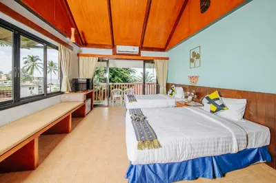 a bedroom with two beds and a balcony at Karona Resort & Spa - SHA Extra Plus in Karon Beach